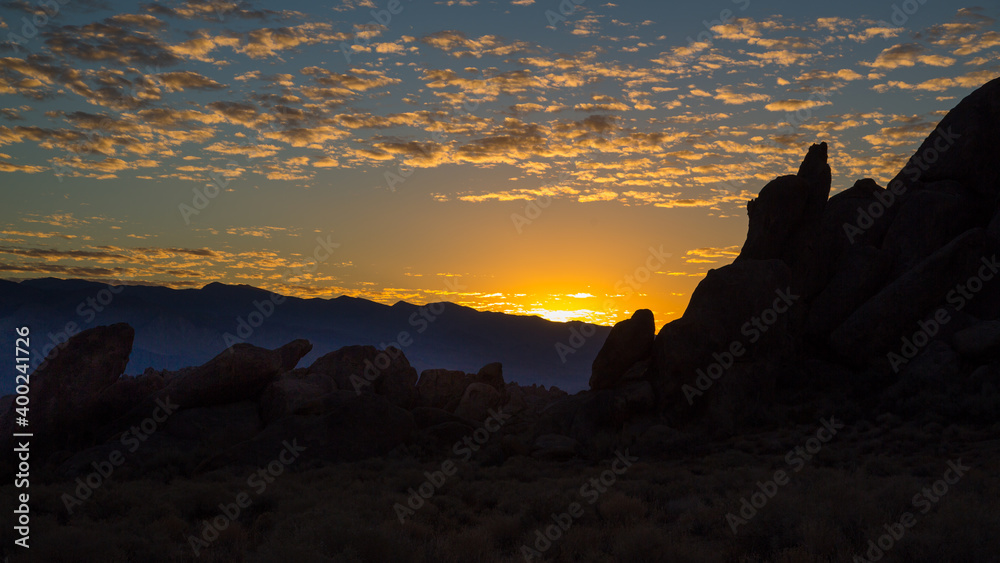 Orange Sunrise Over A Silhouette Of Desert Mountain Peaks