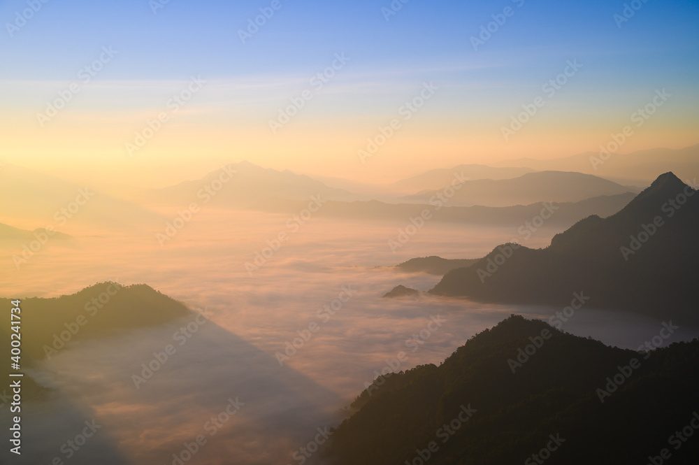 Beautiful misty mountain range in Laos from Phu Chi Fa mountain viewpoint in Chiang Rai province, Thailand