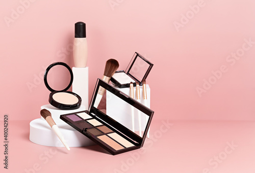 Make up products prsented on white podiums on pink pastel background. photo