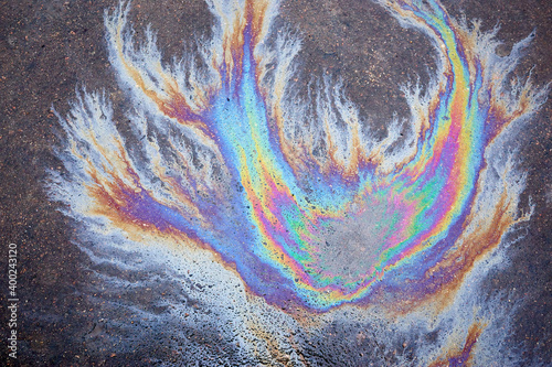 Schilderij op canvas Colored oil stains close up, the color of the gasoline stain on the pavement road as a texture or background