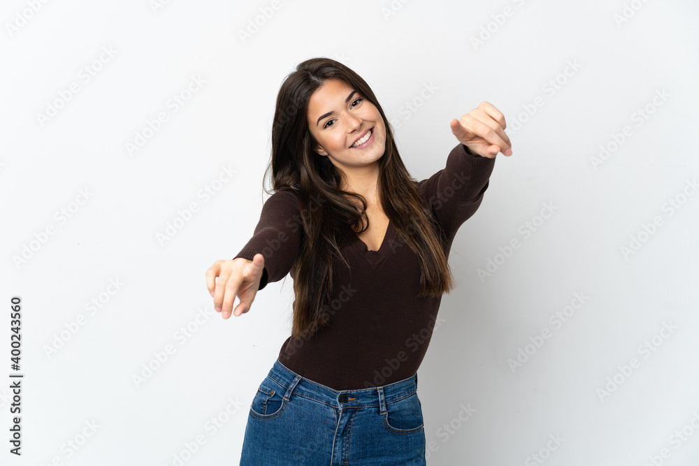 Teenager Brazilian girl isolated on white background pointing front with happy expression Teenager Brazilian girl isolated on white background pointing front with happy expression