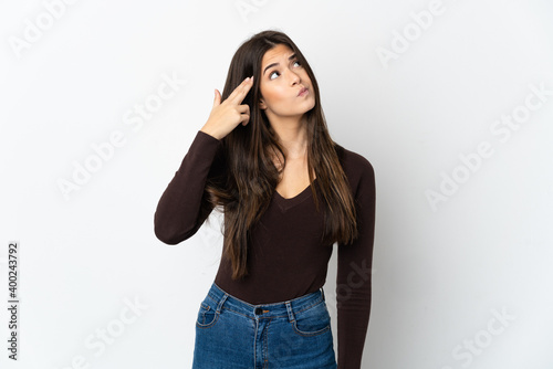 Teenager Brazilian girl isolated on white background with problems making suicide gesture © luismolinero