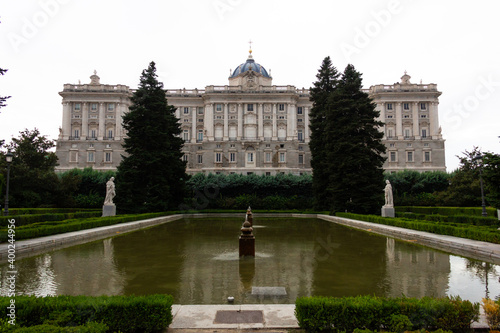 Water fountain pond with Royal Palace of Madrid on background. European landmark, tourist attraction concepts