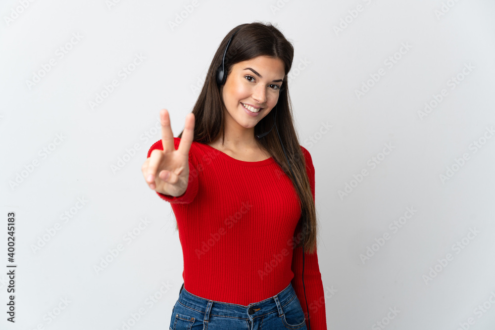 Young Brazilian telemarketer girl over isolated background smiling and showing victory sign Young Brazilian telemarketer girl over isolated background smiling and showing victory sign