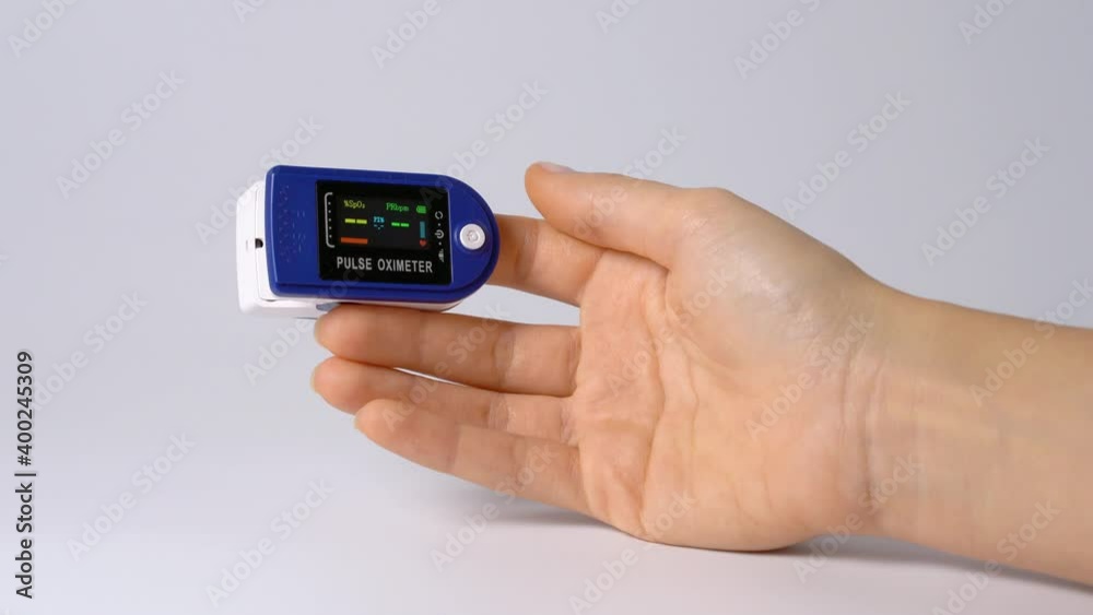 Close-up on a finger, putting on a pulse oximeter to check the pulse of the amount of oxygen in the blood. White background. Diagnosis of a patient by a doctor. Close-up on a finger, putting on a pulse oximeter to check the pulse of the amount of oxygen in the blood. White background. Diagnosis of a patient by a doctor.