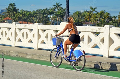 Woman riding a bicycle on the Venetia 
Causeway in Miami Beach,Florida
