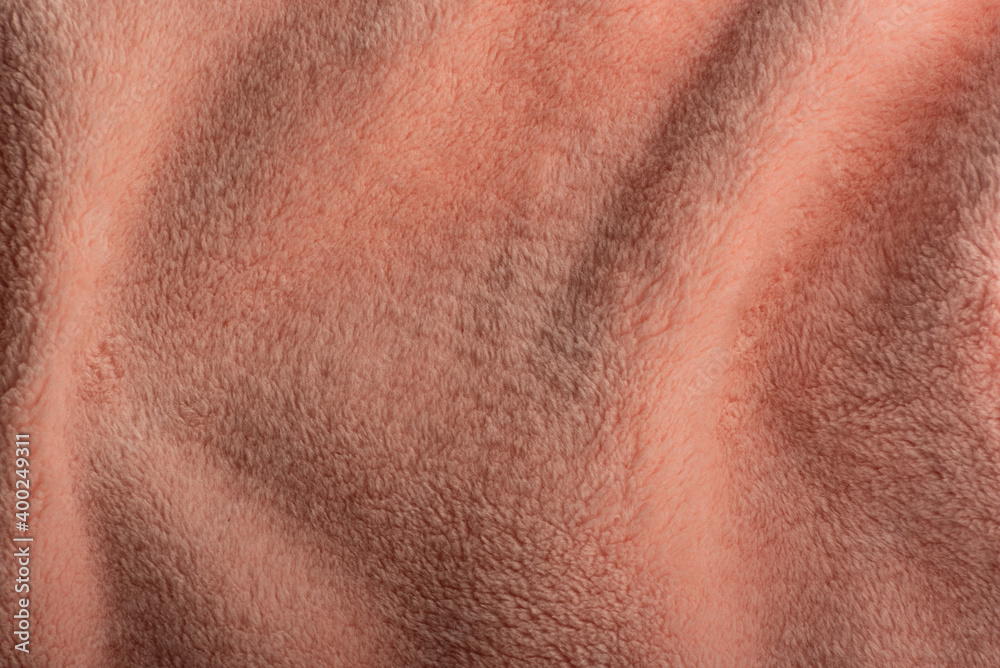Abstract background of apricot color. Fur plaid textile close up Abstract background of apricot color. Fur plaid textile close up