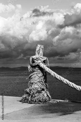 Rope on seafront, sea and beautiful cloudy sky in sunny summer day