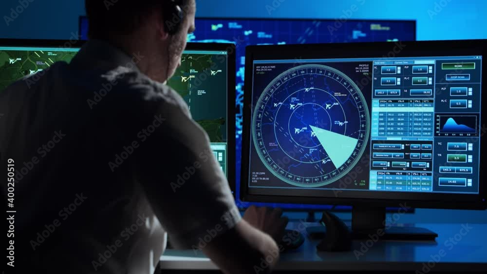 Workplace of the professional air traffic controller in the control tower. Caucasian aircraft control officer works using radar, computer navigation and digital maps.