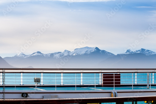A view of snow-capped mountains along the coast of Alaska  seen from the deck of a cruise ship
