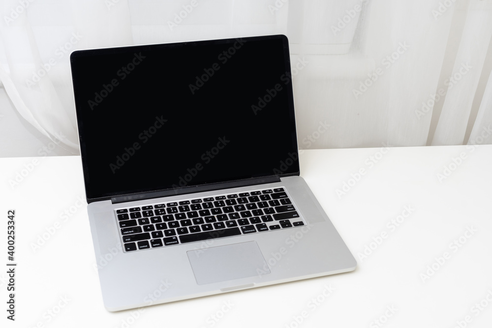 Computer mockup white background on table. Laptop with blank screen
