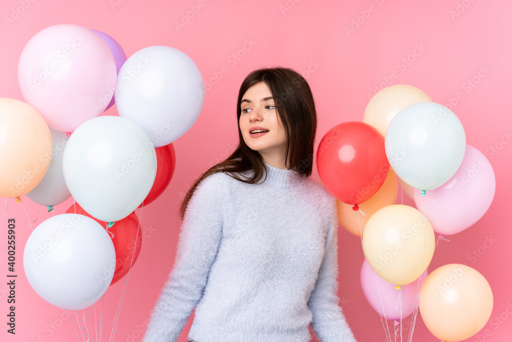 custom made wallpaper toronto digitalYoung Ukrainian teenager girl holding lots of balloons over isolated pink background