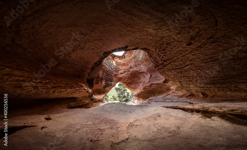 Great mountain cave. Top of the cavern. Image of a cave with a large entrance and a hole or window at the top. Panoramic view of a Neolithic cave. Cave carved in Murcia, Spain photo