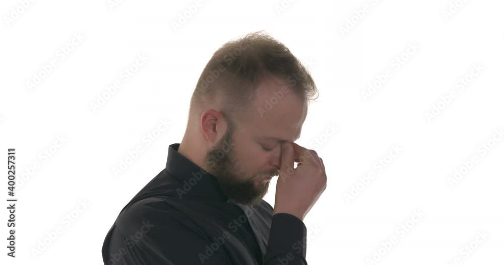 Side view of tired Caucasian priest takes off glasses and feeling eyes strain. Isolated on white background Side view of tired Caucasian priest takes off glasses and feeling eyes strain. Isolated on white background