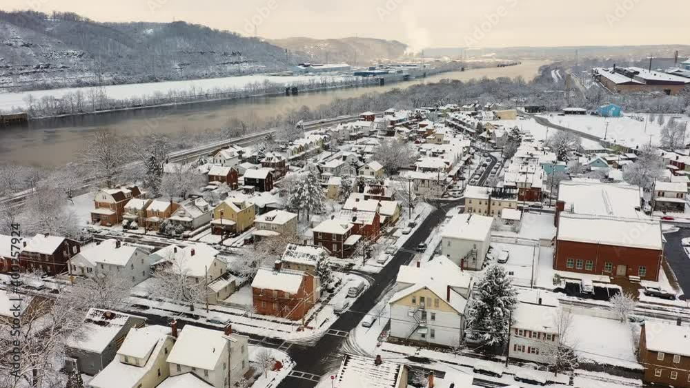 An aerial winter establishing shot view of the homes in the residential district of a small river town. Ohio River in the distance. Pittsburgh suburbs. An aerial winter establishing shot view of the homes in the residential district of a small river town. Ohio River in the distance. Pittsburgh suburbs.