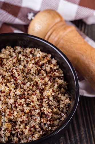 bowl of healthy quinoa on a dark wooden rustic background