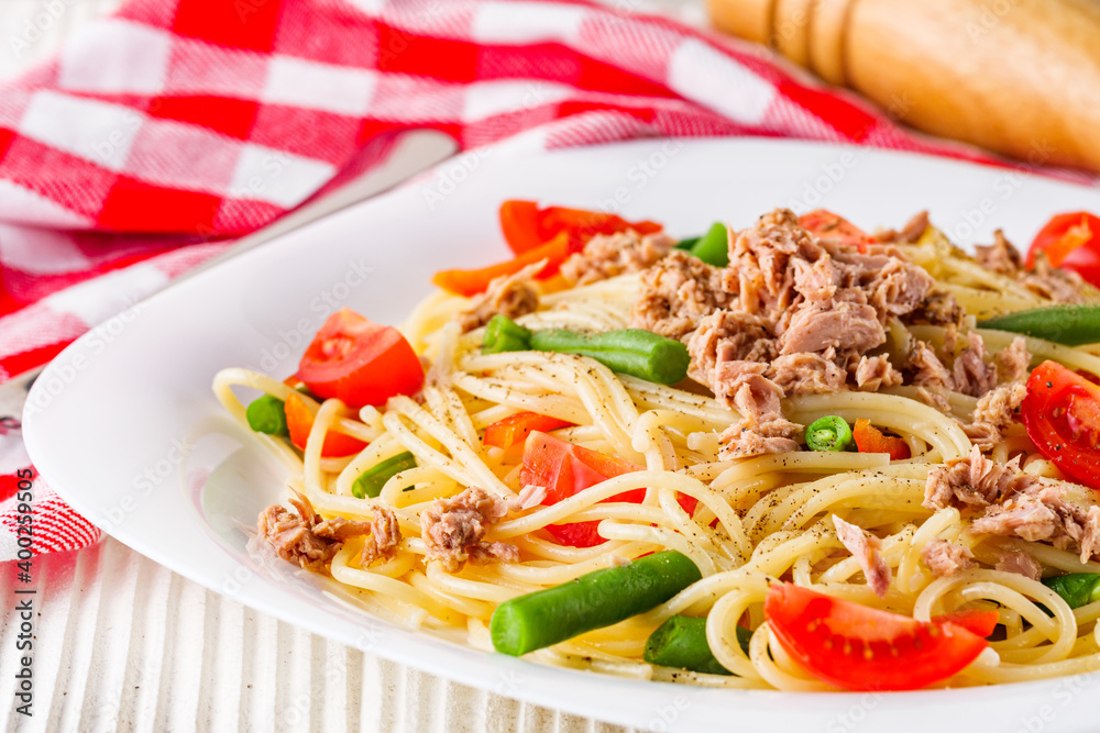 delicious traditional Italian pasta with tuna on a white rustic wooden background delicious traditional Italian pasta with tuna on a white rustic wooden background