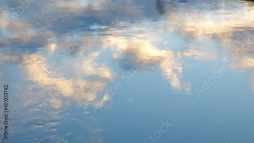 Video of clouds at sunset reflected in the waters of a river