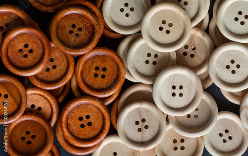 Group of round wooden sewing buttons. Brown and natural wooden sewing buttons. Close up. Macro.