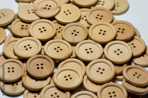 Natural round wooden sewing buttons isolated on white background. Close up. Macro.