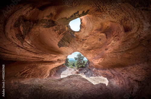 The moon illuminates the interior of the cave. Landscape of a cave with an entrance and a window at the top. Panoramic view of a Neolithic cave in Spain. Cave carved in Yecla, Murcia. 