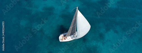 Aerial drone ultra wide photo of beautiful sail boat sailing in turquoise Ionian island sea © aerial-drone
