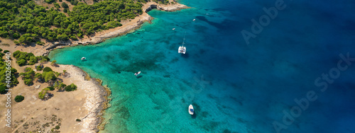 Aerial drone ultra wide photo of exotic bay of Moni island visited by yachts and sail boats  Aegina island  Saronic gulf  Greece