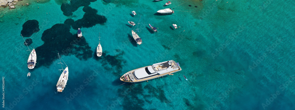 Aerial drone ultra wide top down photo of luxury yacht anchored in tropical exotic bay with emerald crystal clear sea Aerial drone ultra wide top down photo of luxury yacht anchored in tropical exotic bay with emerald crystal clear sea