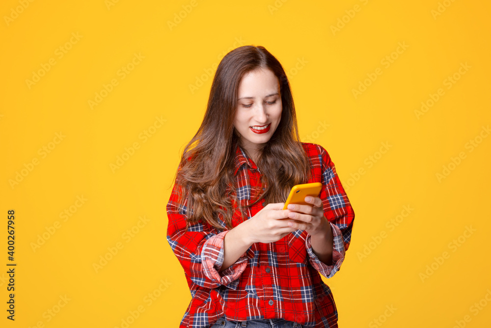 Young woman smiling and using smartphone Young woman smiling and using smartphone