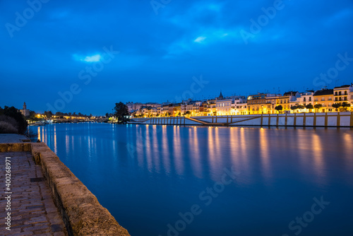 Spain, Seville, Triana, Guadalquivir river at dusk photo