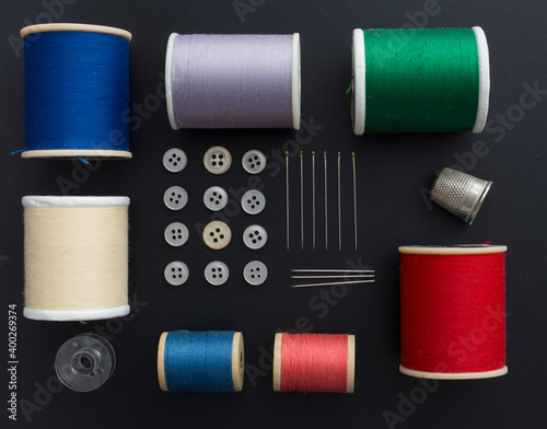 Studio shot of colorful sewing tools on black background photo