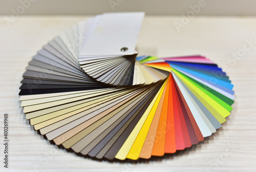 Color palette swatches. Palette of different colors and shades on wood background. Color catalog for tinting facade and interior paints, printing and painting and for wooden facades in furniture