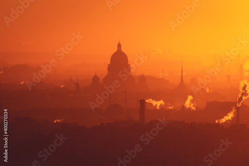 Aerial panoramic view of Saint-Petersburg, Russia, with St. Isaac's cathedral, the Winter Palace and Admiralty, with beautiful vibrant red orange sunset sundown, dusk cityscape silhouette scenery