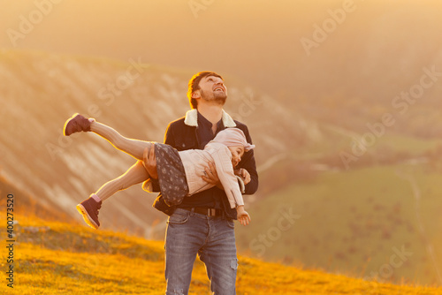 Happy father playing with daughter in nature
