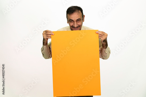 Man holding billboard in his hand. The man is dressed in a white shirt and fabric pants. Isolated image on white background.