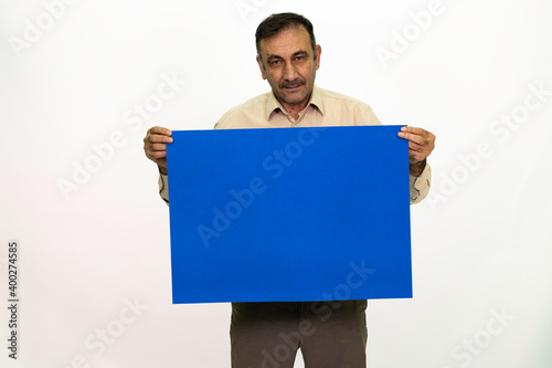 Man holding billboard in his hand. The man is dressed in a white shirt and fabric pants. Isolated image on white background.