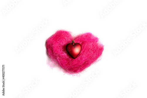 red heart of pink wool on a white background