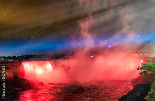 Majestic Niagara Falls at night, illuminated for a light show, view from canadian side