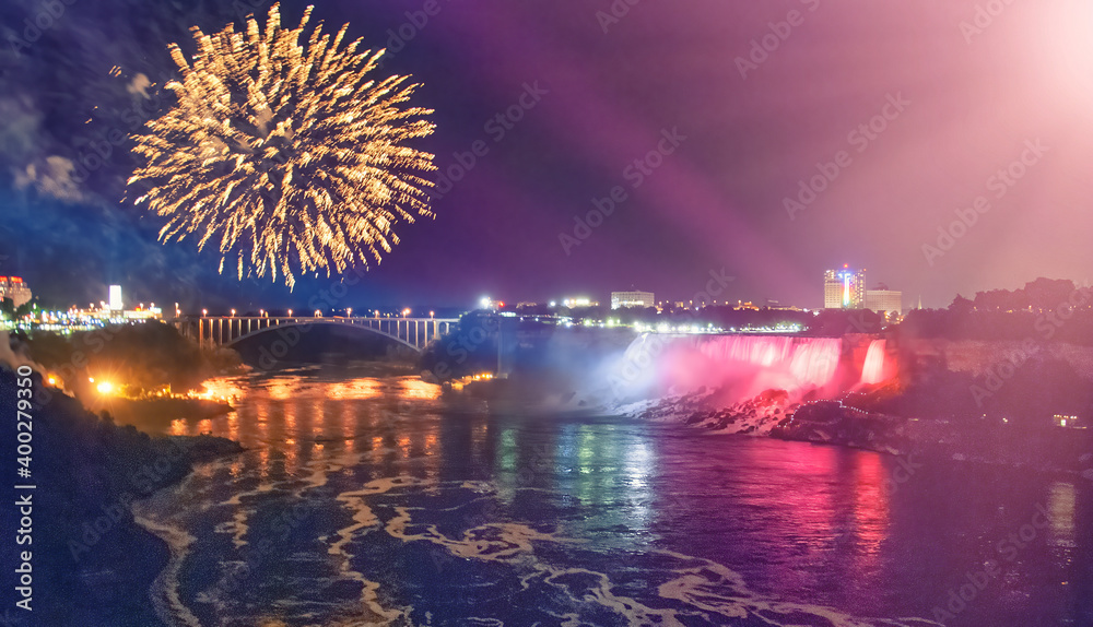Majestic Niagara Falls at night, illuminated for a fireworks show, view from canadian side