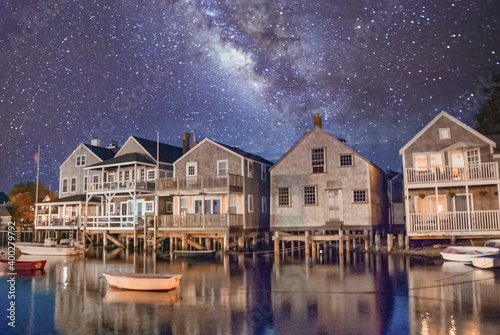 Beautiful homes of Nantucket at night, USA. Ocean reflections and starry night photo