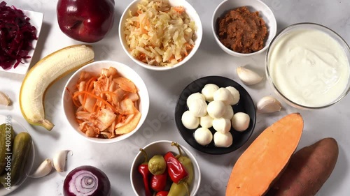 Probiotic and prebiotic such as pickles, sauerkraut, kimchi, miso, fruits good for and healthy gut and immunity. Fermented foods act as antistress. Healthy diet concept. Top view. Camera movement. 4K