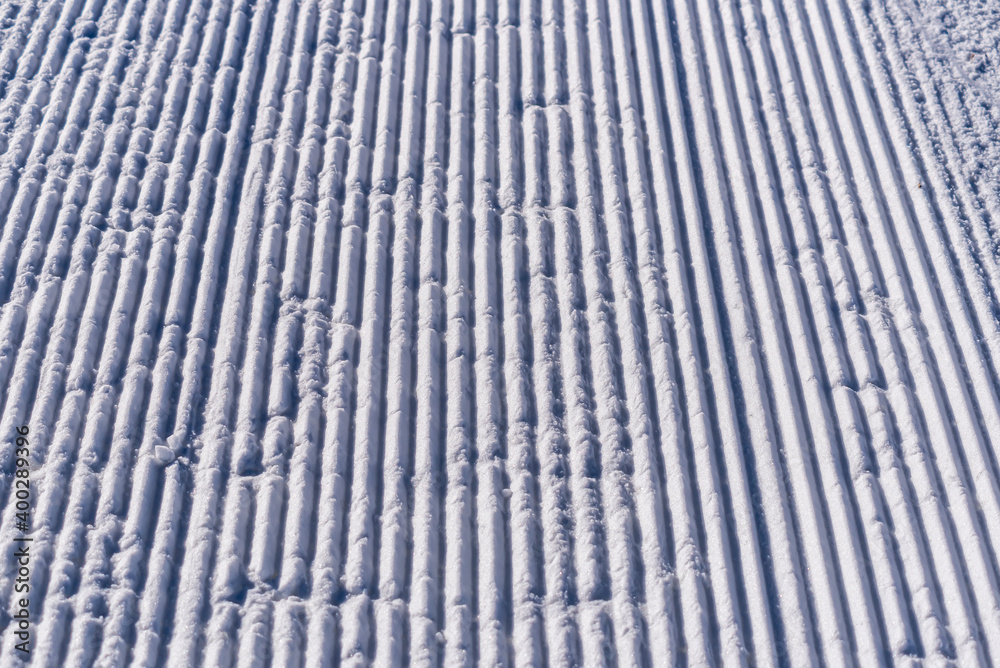 Snow lines texture made from a snow machine on a ski slope. snow traces ...