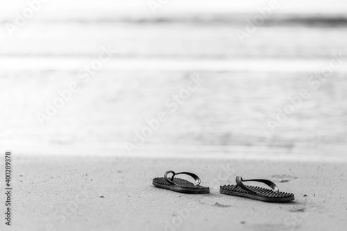 Black and white picture flipflop on the beach.