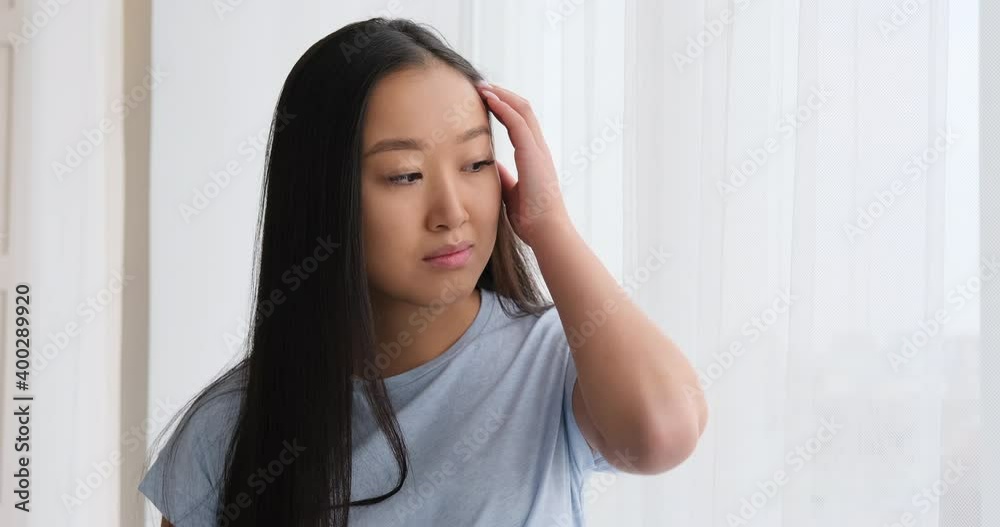 Beautiful smiling woman looking out through window Beautiful smiling woman looking out through window