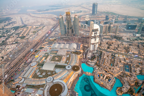 DUBAI, UAE - DECEMBER 4, 2016: Aerial sunset view of Downtown Dubai and city pools from top of the tower