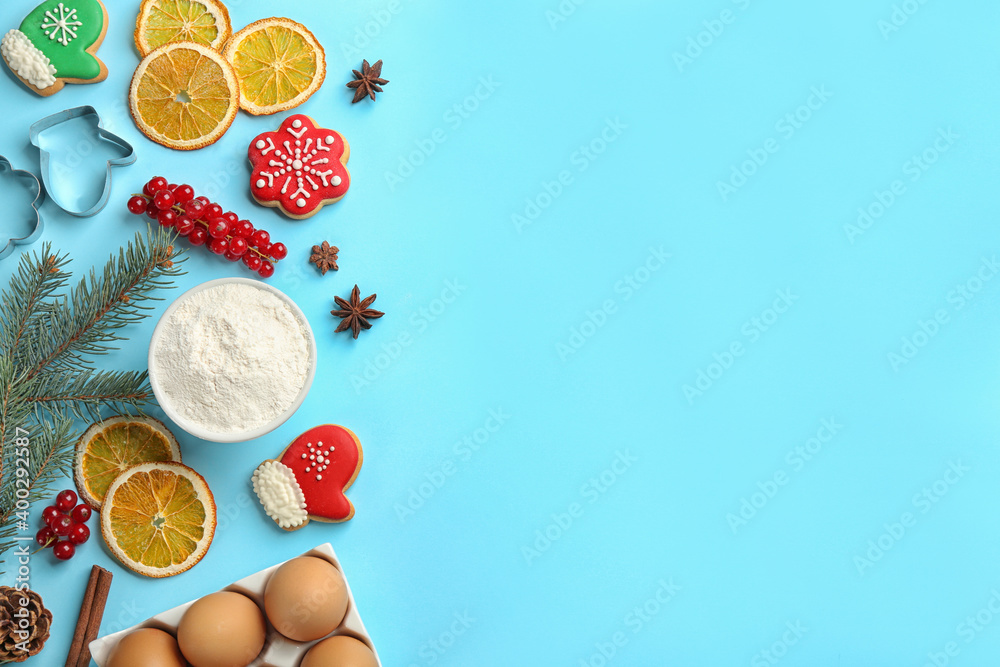 Flat lay composition with Christmas cookies and flour on light blue background. Space for text Flat lay composition with Christmas cookies and flour on light blue background. Space for text