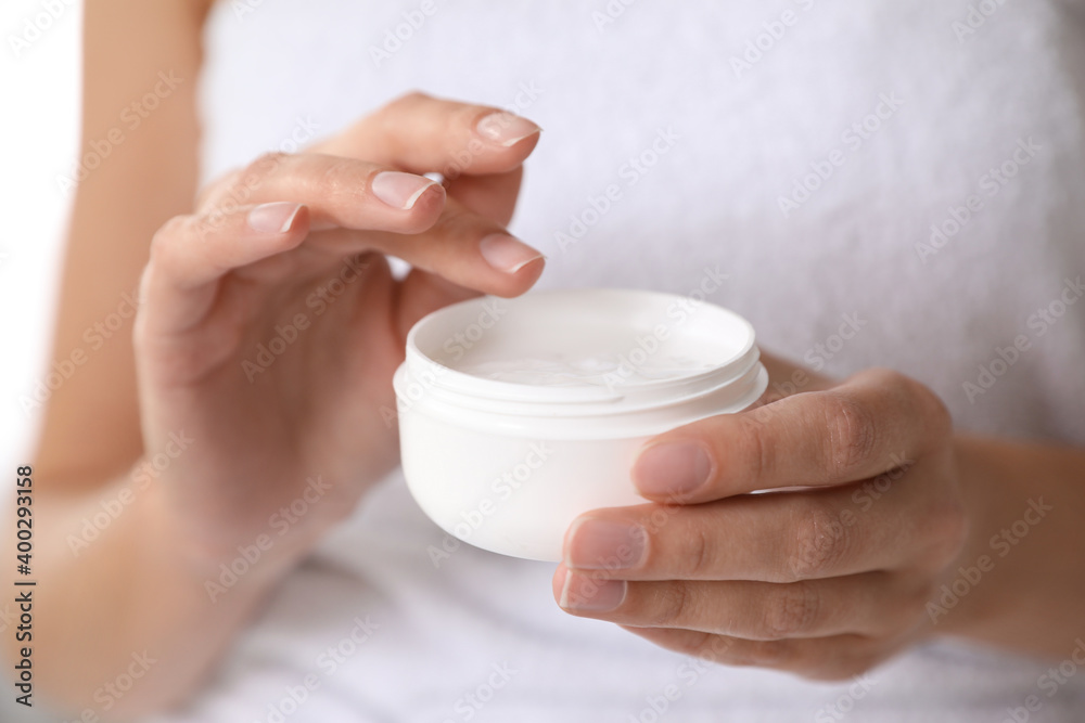 Woman with jar of moisturizing cream, closeup Woman with jar of moisturizing cream, closeup