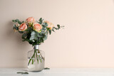 Vase with bouquet of beautiful roses on white wooden table. Space for text
