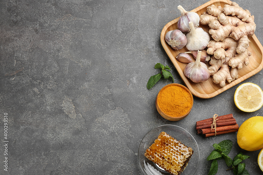 Fototapeta premium Flat lay composition with fresh products on grey table, space for text. Natural antibiotics