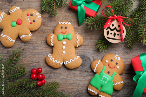 Flat lay composition with gingerbread men on wooden table